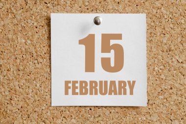 15 Şubat. Ayın 15. günü, takvim tarihi. Kahverengi mantar panoya eklenmiş beyaz takvim kağıdı. Kış ayı, yılın günü konsepti..
