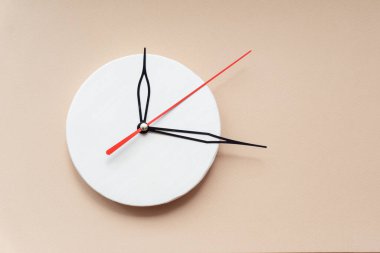 Saatin elleri ahşap kadranda. Yakın plan, izole edilmiş bej arkaplan, kopyalama alanı.