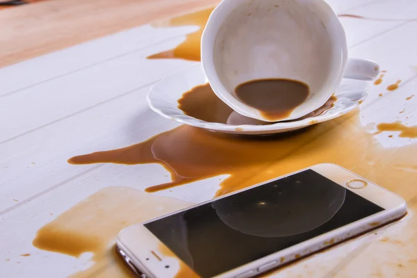 On office desk ,Coffee spilled on phone