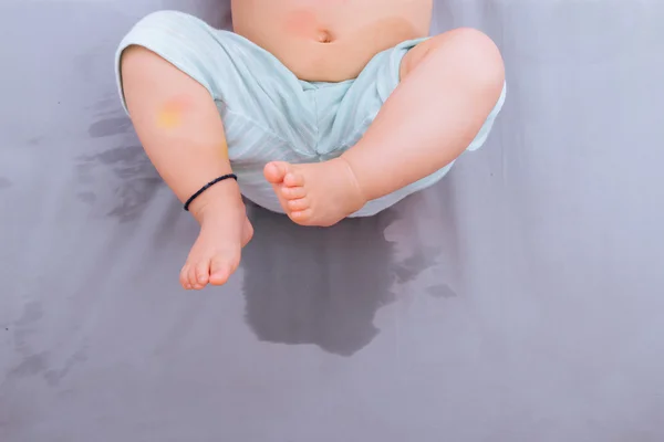 Bambino gioca dopo bagnare il letto del bambino — Foto Stock