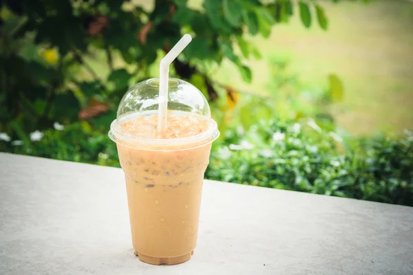 Iced coffee plastic cup for take away to go on wooden table — Stock Photo, Image