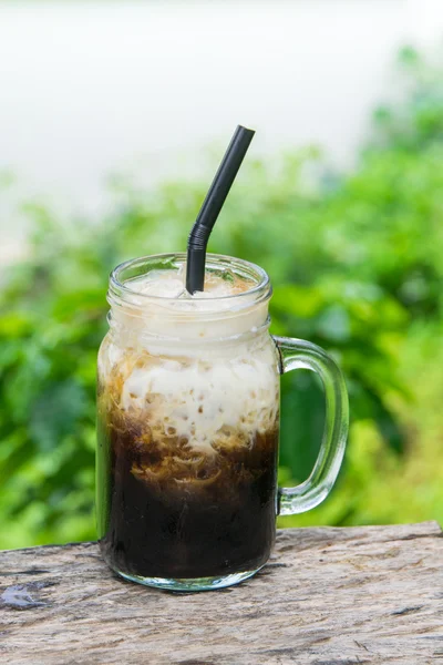 Iced black coffee with fresh milk in jar vintage mug glass cups on the table — Stock Photo, Image