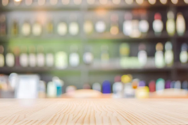 Wooden Table Top with Blurred Wine Liquor bottles Display Background