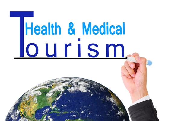 Business man hand writing Health Medical tourism over Earth (Earth map furnished by NASA) — Stock Photo, Image