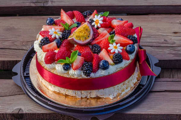 Anna Pavlova French dessert with blackberries,blueberries, passion fruit, raspberries, strawberries. Meringue, Vegetarian, Low fat, Dietary cake.