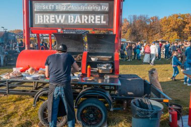 Kazan, Rusya - 03 Ekim 2020: Şehir parkındaki yemek sahasında mobil vintage gıda kamyonu bbq, sahibi hamburger ve sosisli pişiriyor..