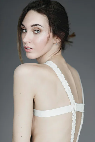 Portrait of a young beautiful girl in the studio on a gray background, the concept of health and beauty — Stock Photo, Image