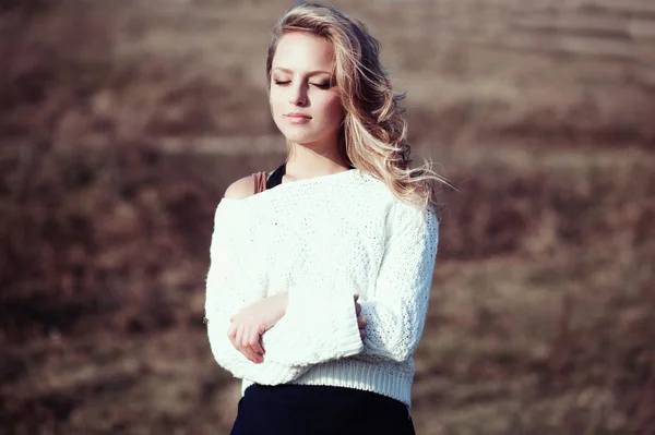 Portrait of a beautiful young blonde girl in a field — Stock Photo, Image