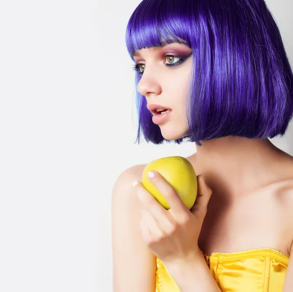 Chica con peluca y manzana — Foto de Stock