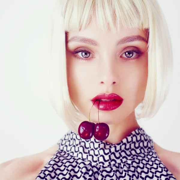 Girl with cherries in the mouth — Stock Photo, Image