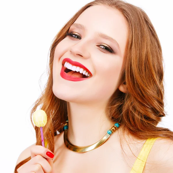 Woman with bright makeup eating candy — Stock Photo, Image