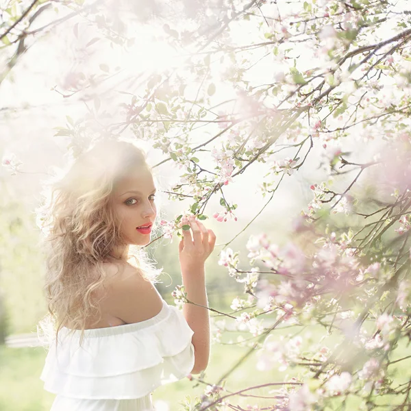 Girl in the flowered garden — Stock Photo, Image