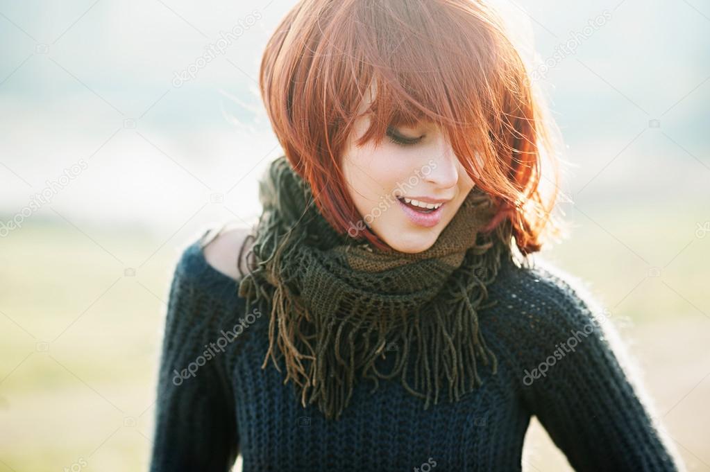 girl with red hair  wearing a warm pullover