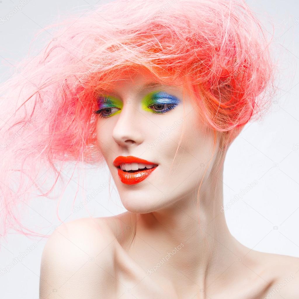 model with bright  makeup and  pink hair