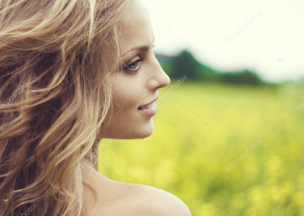 young blond girl in a field