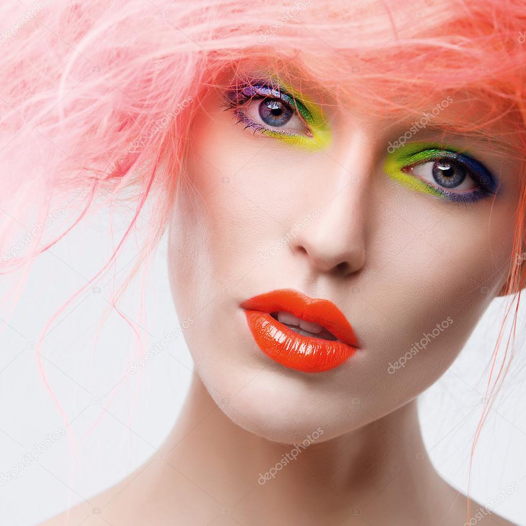 model with bright  makeup and  pink hair