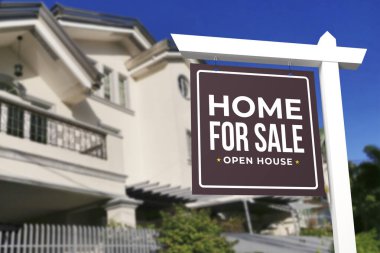 A Home for sale and open house sign in front of a large gated house. clipart