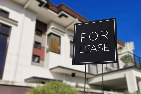 A modern Home For Lease Sign in front of a large 2 storey house. Minimalist Real Estate Signage.