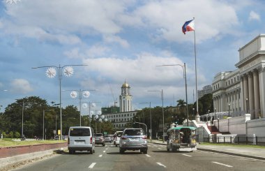 Manila, Philippines - Manila City Hall as seen from Padre Burgos Avenue. National Museum of the Philippines at the right of the photo. Driver's POV. clipart