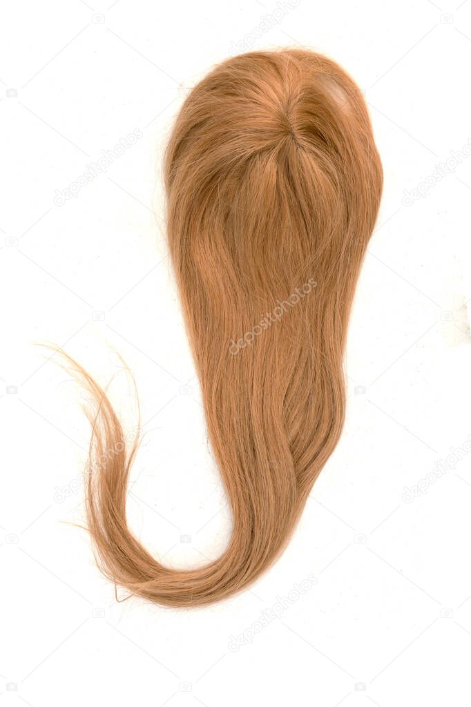 A blonde wig or hair topper with the ends curled to the left. Set against a white backdrop.