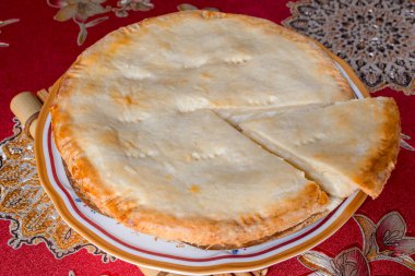 A whole buko pie with a sliced portion. It is a traditional Filipino baked young-coconut custard pie. clipart