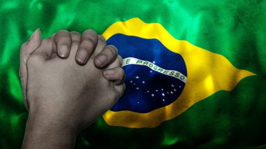 A hand praying with Flag of Brazil as background. Grunge, depressing look. Can represent adversity, crisis, Christian or Catholic prayer, forgiveness, worship or plea in country. clipart