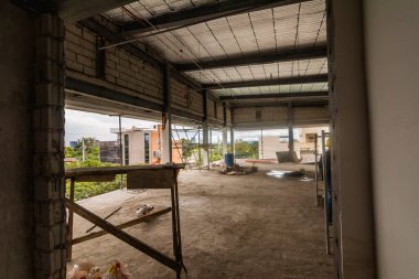 Muntinlupa, Philippines - Jan 2021: Inside a typical floor plate of a midrise commercial building under construction. Walls, ceilings and partitions have not been installed yet.