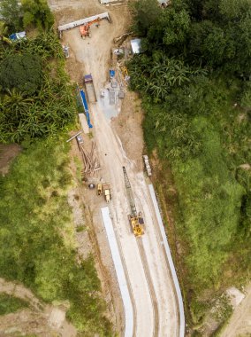 Top view of a highway under construction, cutting through a rural area. Idle worksite due to the weekends. In Dasmarinas, Cavite.