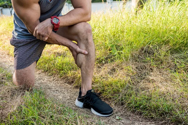 Cropped shot of an athletic man having calf muscle cramps. Endurance issues during outdoor run.