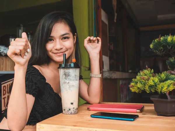 Cute Attractive Young Filipina Woman Gives Thumbs Sign While Sipping — Stock Photo, Image
