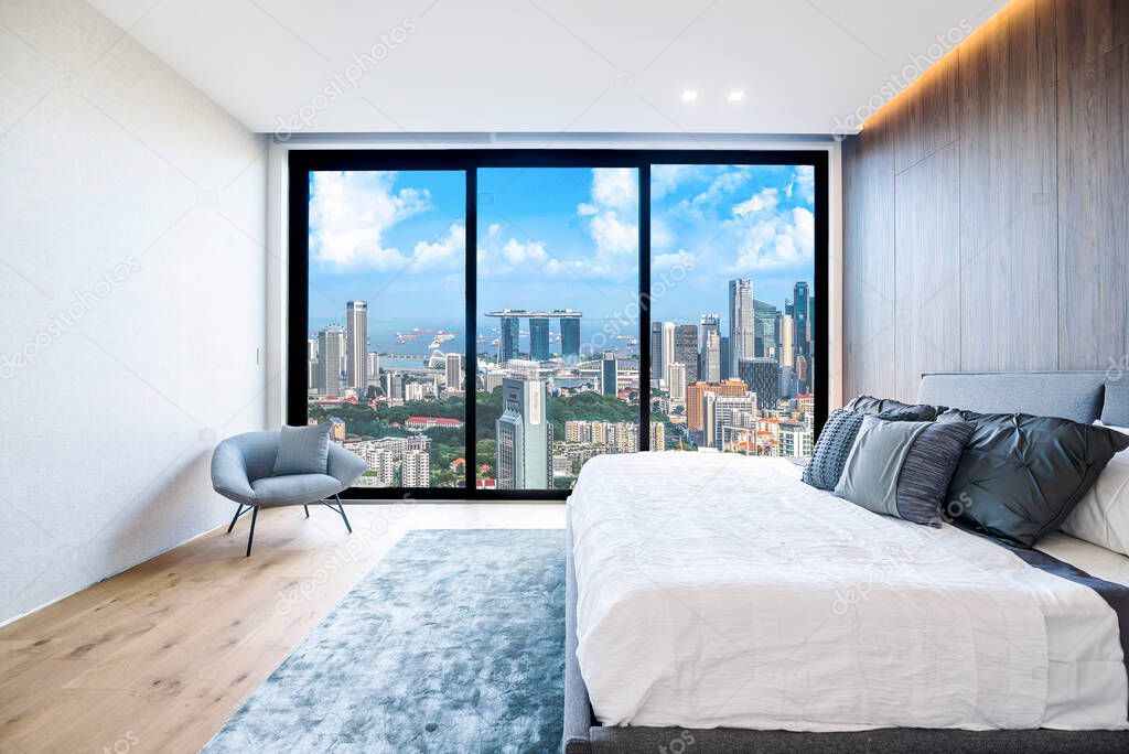 Singapore - April 2019: Interior of a modern minimalist bedroom with views of the city and MBS.