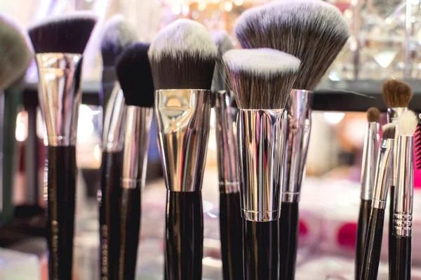 Closeup of colorful cosmetic makeup brushes for sale at a beauty store.