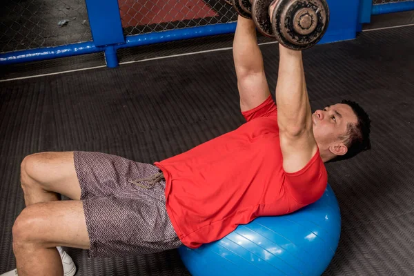 Fit Athletic Asian Guy Does Swiss Ball Dumbbell Chest Press — Stock Photo, Image