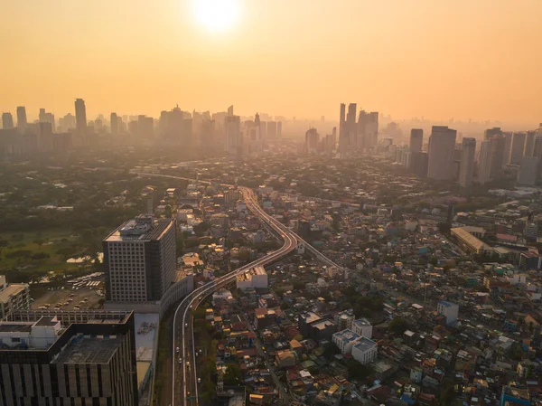 Dramatic sundown against the hazy Makati skyline, as seen from BGC area. In Metro Manila, Philippines.
