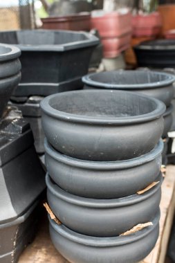 Various painted Terracotta clay pots for sale at a garden supplies store.