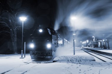 Steam locomotive ready to go in snow storm, Germany clipart