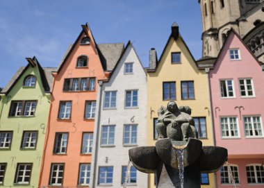 Fountain near the colorful houses in the Old Town of Cologne, Germany clipart