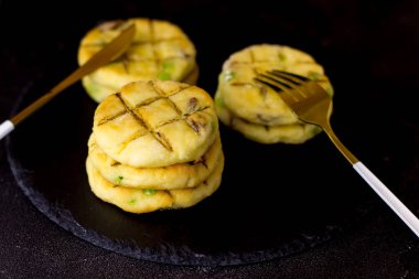 Siyah arka planda bir tabak tabakta peynirli kek.