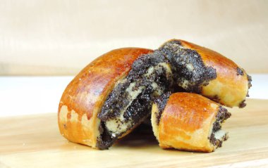 Tahta bir yüzeyde haşhaş tohumu rulosu, yakın çekim, seçici odaklanma