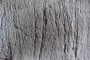    Beton, derin çizikler, çimento ve küçük taşlar karışımından yapılmış gri alçı. duvar dokusu arkaplanı.       
