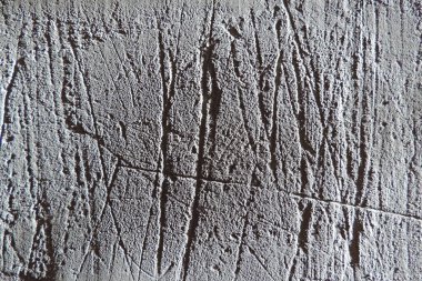 Beton, derin çizikler, çimento ve küçük taşlar karışımından yapılmış gri alçı. duvar dokusu arkaplanı.          