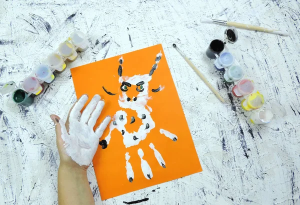 drawn horned animal on orange background. DIY, year of the ox craft activity for kids. symbol of the new year 2021