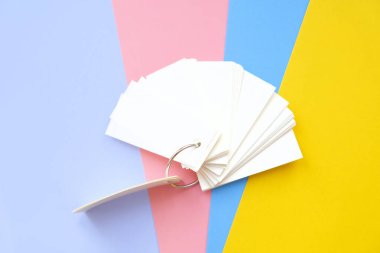 Metal bir halkayla bağlanmış kağıt ve boş kağıtların çoklu renkli arkaplanı, boşluğu kopyala