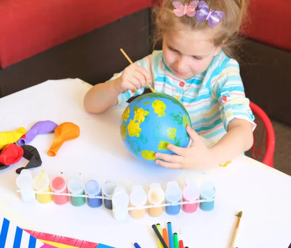 Child drawing pattern of paints fun smile on the balloon. Fun toy. Arts  crafts concept. art learning and education