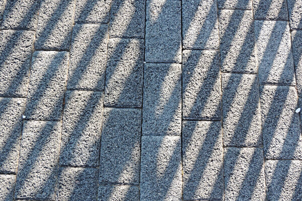 Textured surface brick stone concrete and shadow stripes