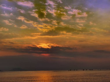 A small fishing boats floated on the sea water in the morning, fishermen sailed small boats during sunrise.  Fishermen at work. Breathtaking seaside
