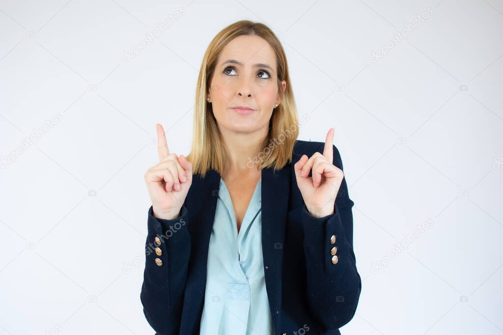Portrait of young business woman pointing at white background