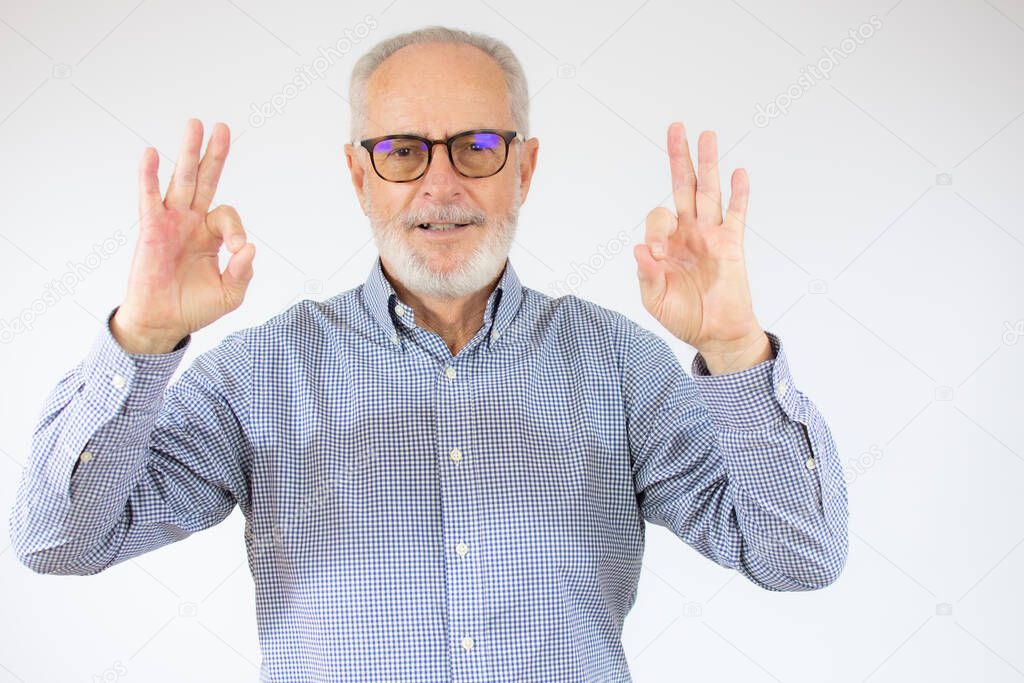 happy positive handsome old man shows Okay sign, no problems, health is Okay everything is okay. close up portrait. isolated white background. happiness, success concept.