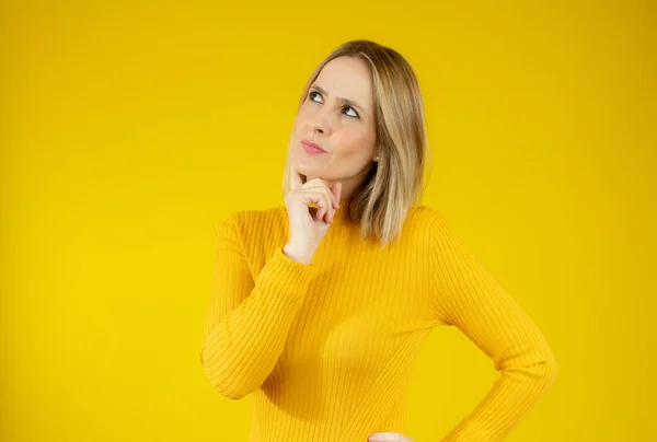 Young Woman Wearing Casual Sweater Doubtful Gesture Yellow Background — Stock Photo, Image