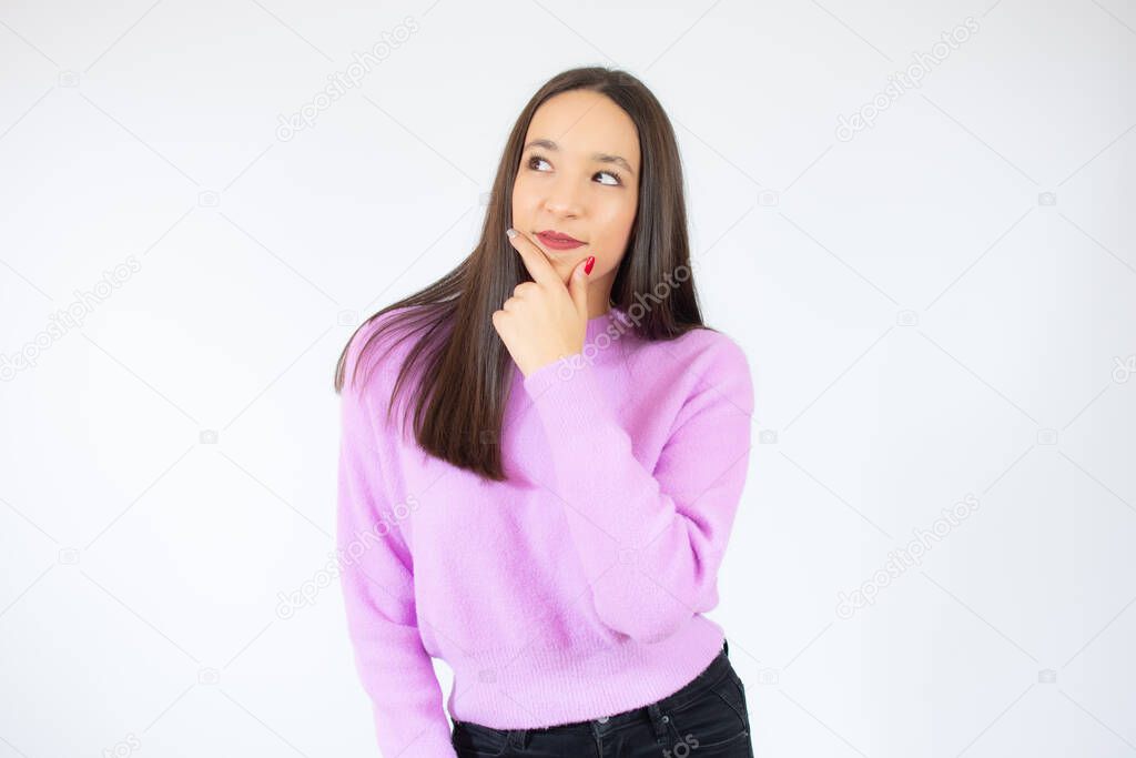 Thoughtful attractive young woman thinking and looking away over white background